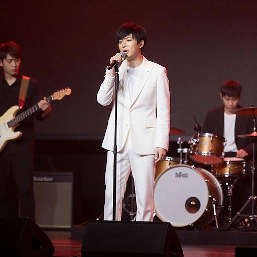 White-Suited Singer on Red-Black Stage