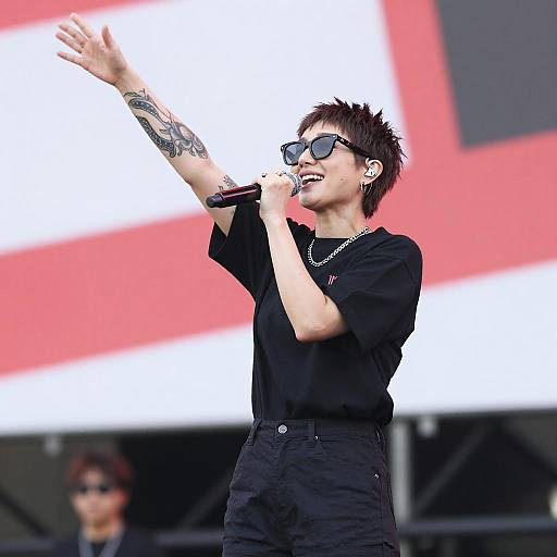 Tattooed Woman Singing Passionately on Stage