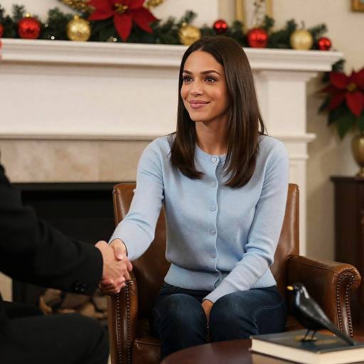 Woman Shaking Hands by Festive Fireplace
