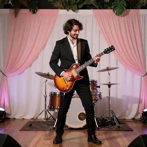 Male Musician Playing Electric Guitar on Stage