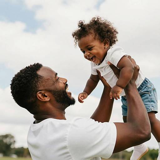 Joyful Father Lifting Laughing Daughter