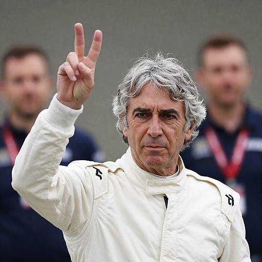 Older Man in White Racing Suit Showing Victory Sign