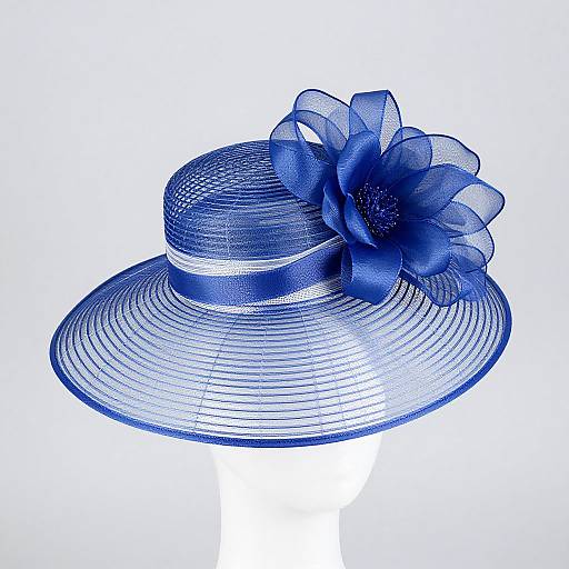 Photograph of a blue, translucent, wide-brimmed hat with a large, detailed flower decoration on the side, set against a white background.