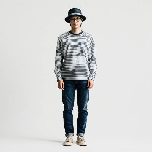 Young man in striped shirt and hat standing