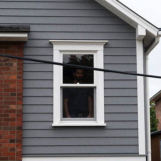 Man Standing Behind House Window