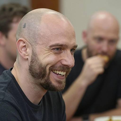 Smiling Bald Man with Goatee and Tattoo
