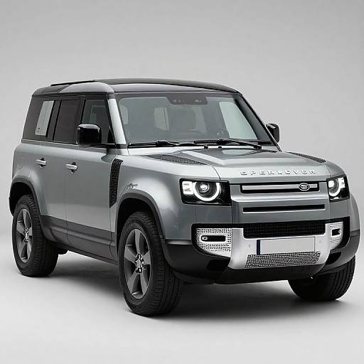 Photograph of a silver Land Rover Discovery SUV with black roof, LED headlights, and black wheels, set against a white background.