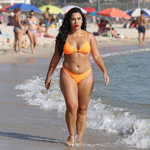 Confident Woman in Orange Bikini at Beach