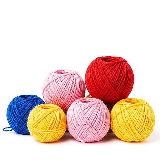 Photograph of six colorful yarn balls: two red, two pink, one blue, and one yellow, arranged on a white background.