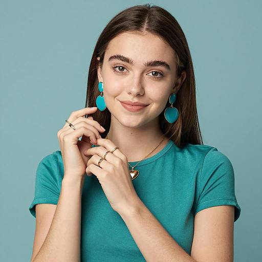 Smiling young woman in teal with gold accessories