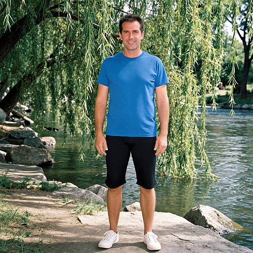 Man in Blue T-Shirt by Riverbank