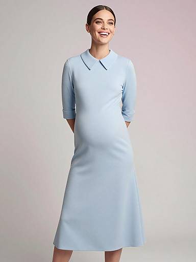Smiling Pregnant Woman in Powder Blue Maternity Dress