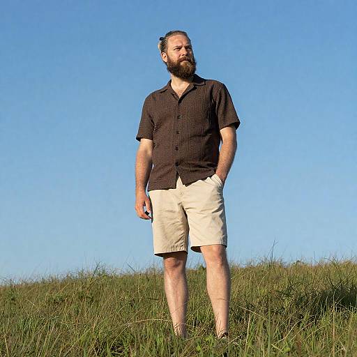 Bearded Man on Grassy Hill with Object