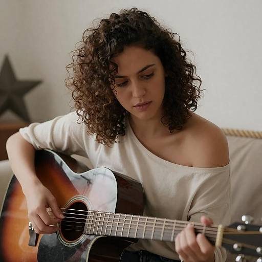 Focused Musician Playing Acoustic Guitar