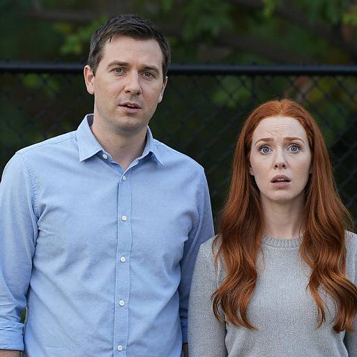 Surprised Couple by Chain-Link Fence