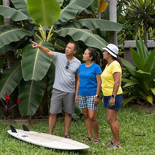 Three People in Tropical Garden with Surfboard