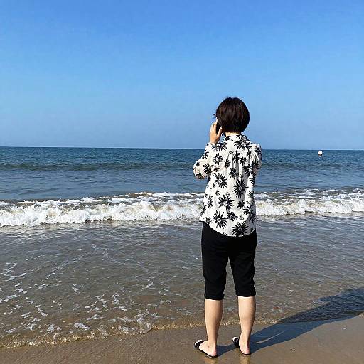 Person on Beach Talking on Phone