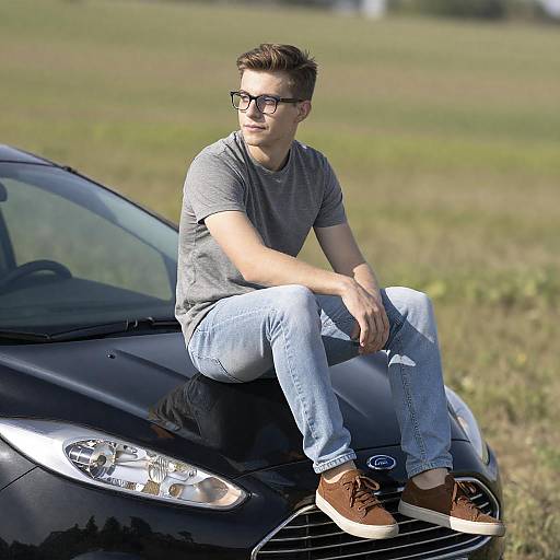 Young Man Sitting on Ford Car Hood