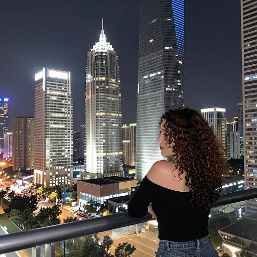 Elegant Woman Overlooking City Skyline at Night