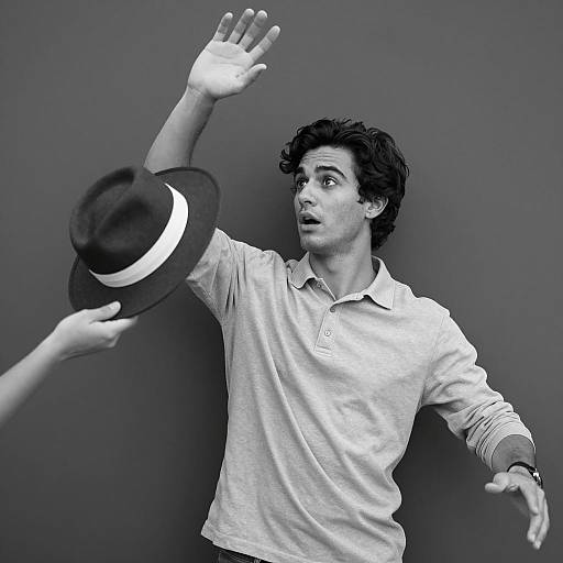 Surprised Young Man Raising Hand