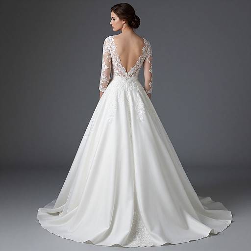 Photograph of a woman in a white, lace-trimmed, long-sleeve, deep-back wedding gown with a full, flowing skirt,