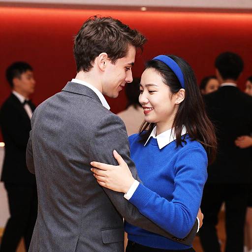 Young Couple Dancing Against Red Background
