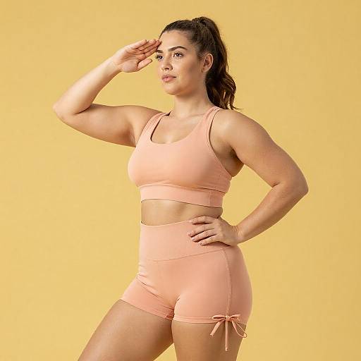 Curvy Woman Saluting in Peach Activewear