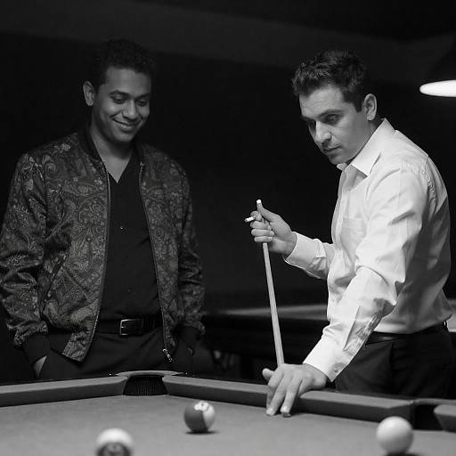 Two Men Playing Pool in Dimly Lit Room