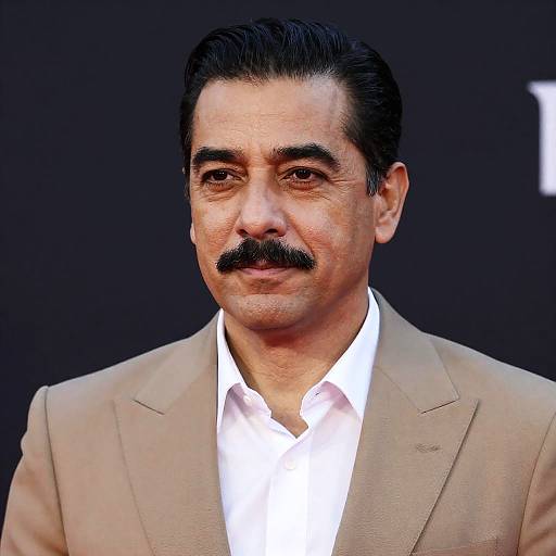 Middle-aged man in tan suit with mustache