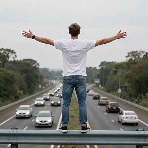 Man Balancing on Highway Guardrail
