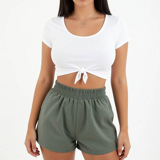 Photograph of a woman with medium skin tone wearing a white, tied-front, short-sleeve top and gray, elastic waistband shorts. She