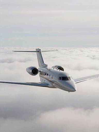 Sleek Metallic Private Jet Above Clouds