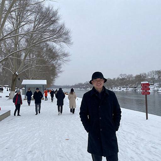 Snowy Riverside Park with Smiling Man