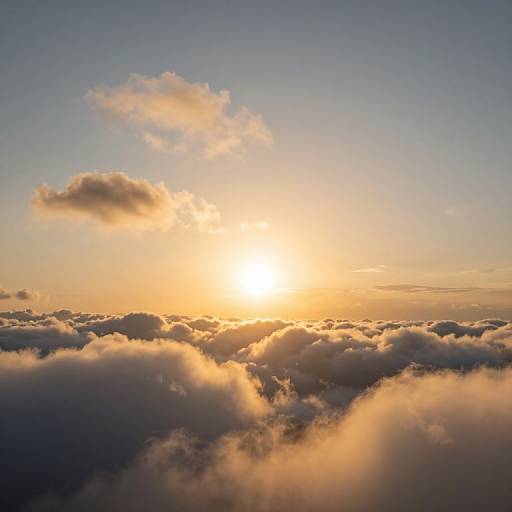 Photograph of a serene sunset over a sea of fluffy, golden-hued clouds with a single cloud illuminated by the sun's warm light.
