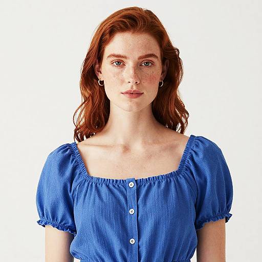 Red-haired woman in blue summer top