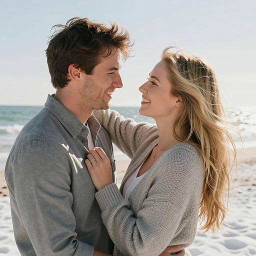 Smiling Couple Embracing at Snowy Beach