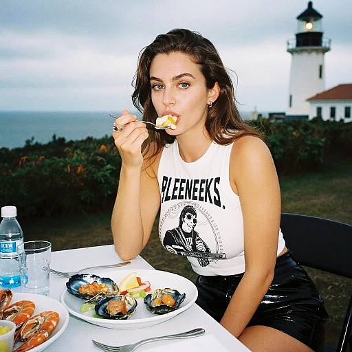 Photograph of a young woman with long brown hair, wearing a white 