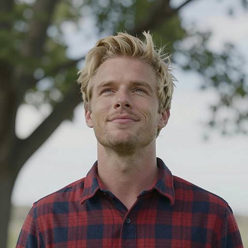 Blonde Man Smiling Under a Tree