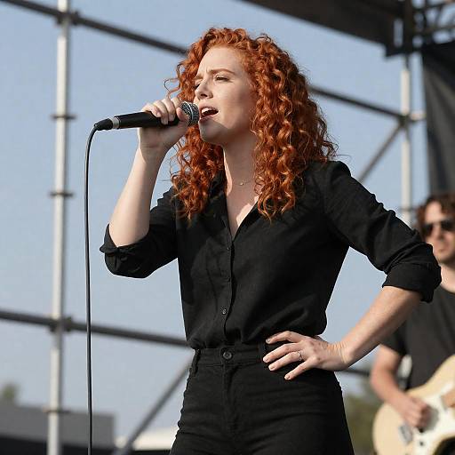 Red-Haired Singer Performing Under Blue Sky