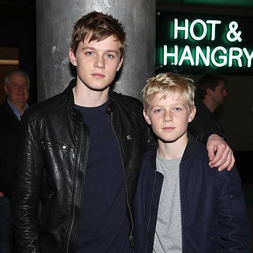 Two Boys Posing Near Metallic Pillar