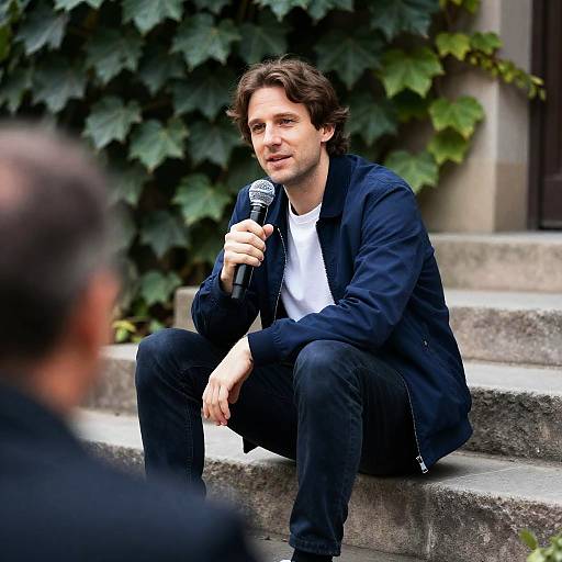 Man on Steps with Microphone Outdoors