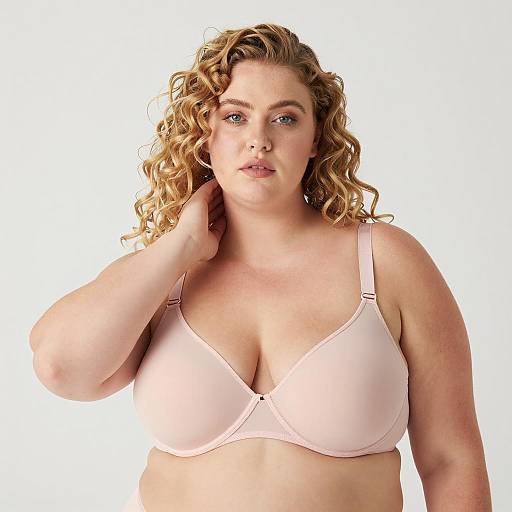 Plus-sized woman in light pink bra