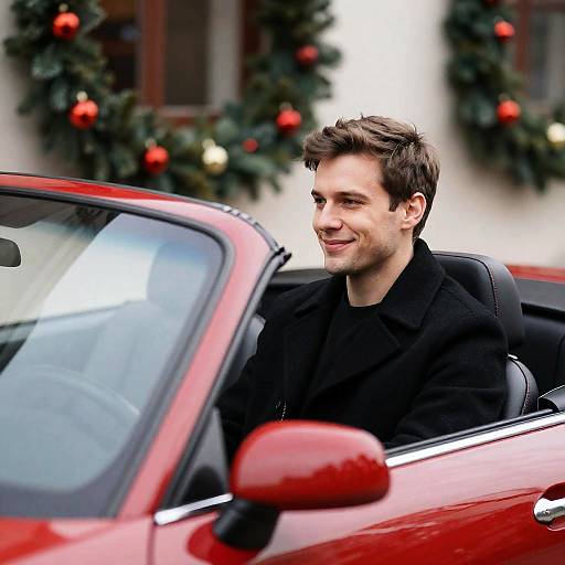 Cheerful Man in Red Convertible at Christmas