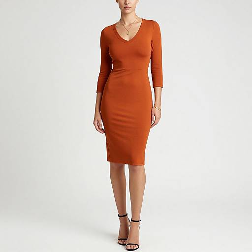Photograph of a woman in a form-fitting, knee-length, orange dress with three-quarter sleeves, black strappy heels, and a simple necklace