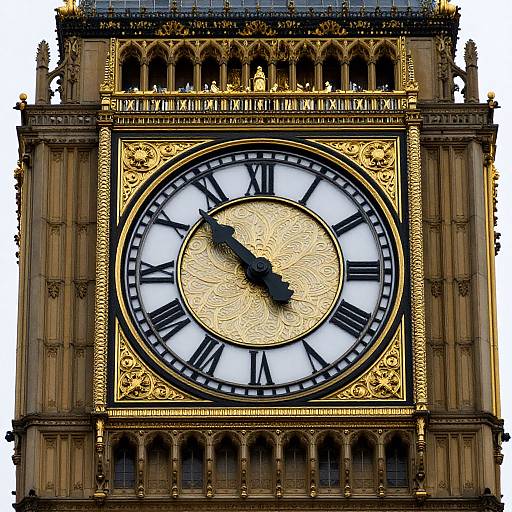 Photograph of the ornate Big Ben clock tower, showcasing a golden, intricately designed clock face with black Roman numerals and hands, against a