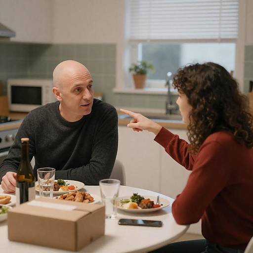 Couple Having Conversation at Kitchen Table