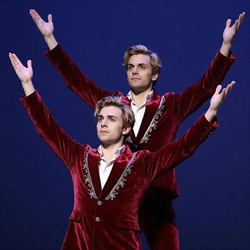 Two Men in Red Velvet Suits Performing on Stage