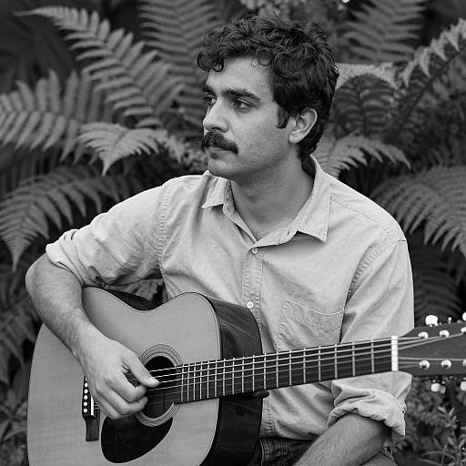 Thoughtful Man with Guitar in Nature