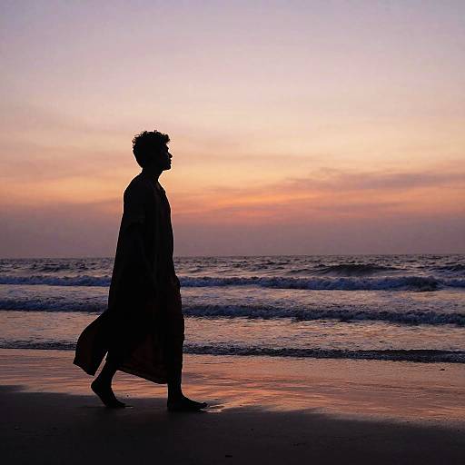 Silhouetted Figure Walking Beach Sunset