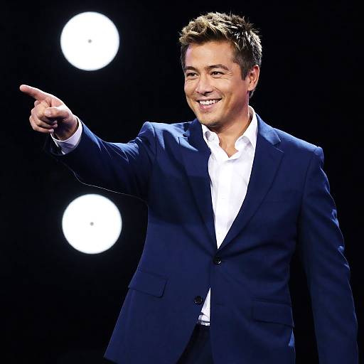 Smiling Man in Dark Suit on Stage